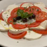 Mozzarella Capri · Sliced homemade mozzarella, sliced fresh tomatoes, basil, and Italian olives.