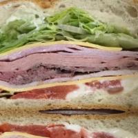 American  Combo · Deluxe ham, roast beef ,oven gold turkey , bologna ,American cheese, lettuce and tomato
