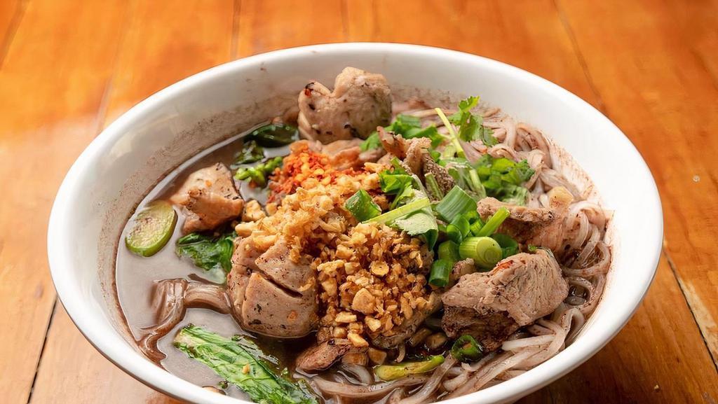 Num Tok · Rice noodles with pork blood broth comes with pork, pork meatballs, Chinese broccoli, bean sprout topped with fried garlic, thai white pepper and cilantro-scallion.