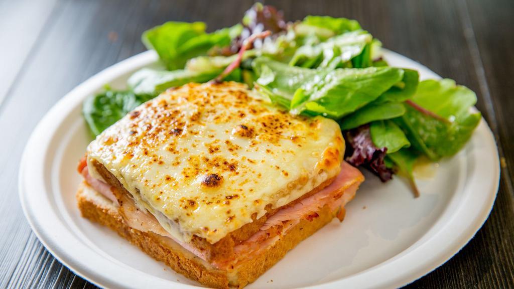 Croque Monsieur · White bread with bechamel sauce, French ham and melted Swiss cheese. Served with a side of mesclun mix salad.