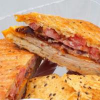 Turkey & Cheddar Grilled Cheese · Sliced turkey, cheddar cheese, bacon, tomato on herb focaccia w/honey dijon sauce. Served wi...