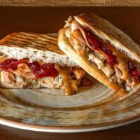 Thanksgiving Panini · Roasted turkey breast, herb stuffing, gravy & cranberry sauce on herb focaccia. Served with ...