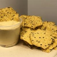 Hummus & Chips · Our homemade garlic hummus with multigrain tortilla chips.