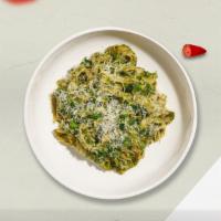 Proper Pesto Pasta  · (Vegetarian) Fresh fettuccine pasta cooked in a pesto sauce and topped with black pepper, pa...