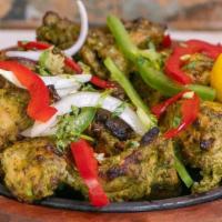 Haryali Murgh Tikka · Chicken thighs marinated in a blended mixture of mint & coriander leaves, curd along with a ...