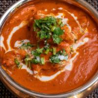 Butter Chicken · Charcoal roasted tender chicken simmered, in a tomato sauce, finished with butter & cream