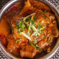 Goat Curry · Goat meat simmered in a zesty sauce of ginger, garlic, onions & spices