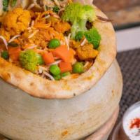 Vegetable Biryani · An exotic blend of basmati rice, assorted vegetables and traditional spices and herbs. Serve...