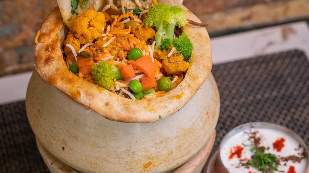 Vegetable Biryani · An exotic blend of basmati rice, assorted vegetables and traditional spices and herbs. Served with Raita.