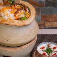 Goat Biryani · An exotic blend of basmati rice, assorted vegetables and traditional spices and herbs, layer...