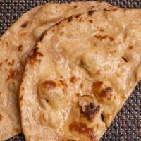 Tandoori Roti · Whole wheat bread baked in a traditional clay oven, an excellent accompaniment to any of our...
