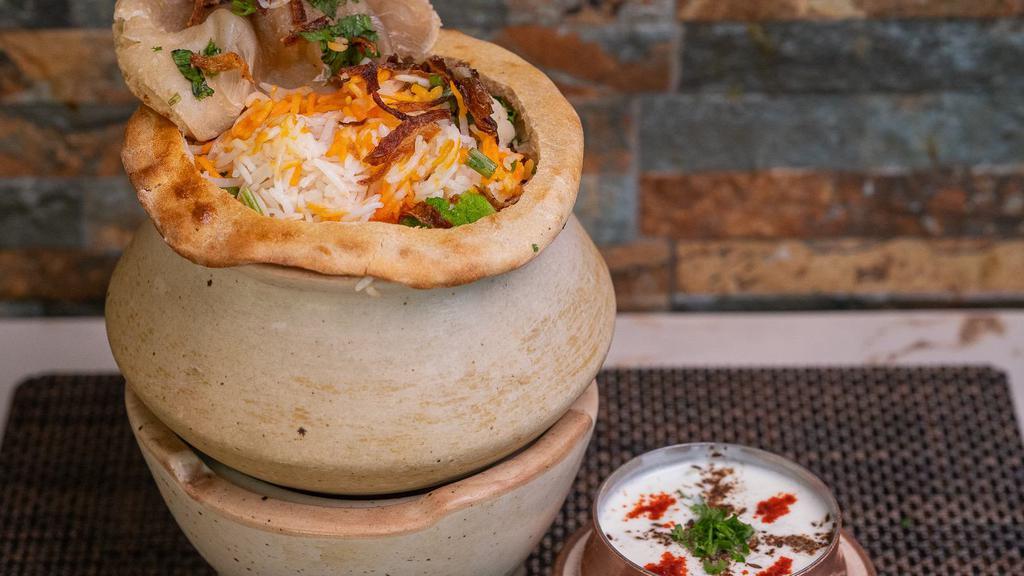 Gosht Biryani · An exotic blend of basmati rice, assorted vegetables and traditional spices and herbs, layered with lamb. Served with Raita.
