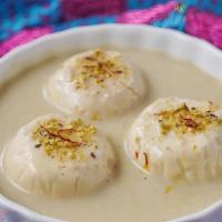 Rasmalai · Light, spongy drops prepared in sweetened milk, flavored with cardamom and pistachio
