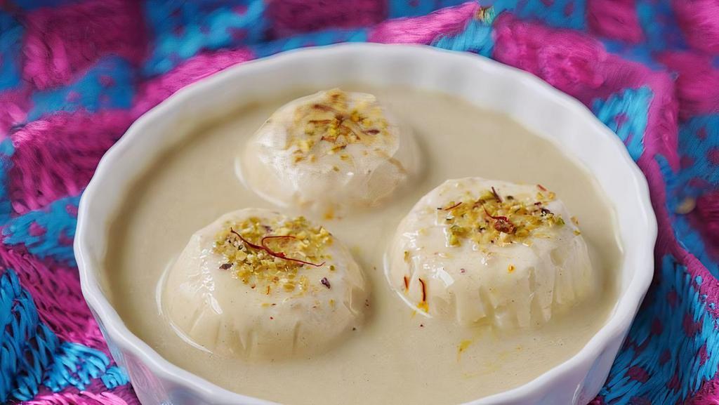 Rasmalai · Light, spongy drops prepared in sweetened milk, flavored with cardamom and pistachio
