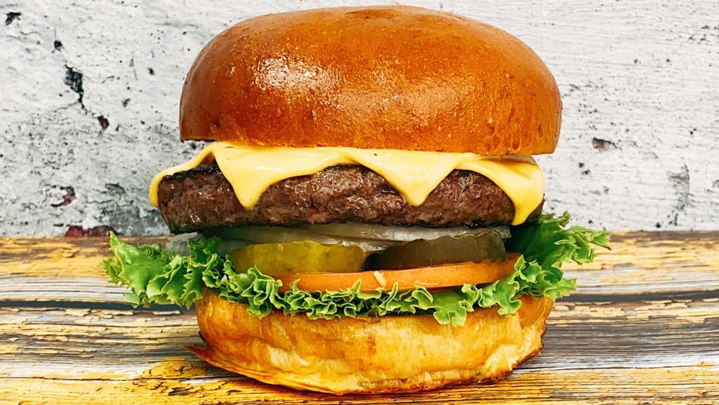 American Wagyu Cheese Burger · 6 oz American Wagyu beef patty, brioche burger bun, two slices of American cheese, lettuce, tomato, onion, pickles.