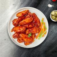 Buffalo Wild Wings  · Fresh chicken wings breaded, fried until golden brown, and tossed in buffalo sauce. Served w...