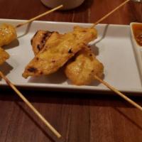 Chicken Satay · Chicken on skewer serve with cucumber salad and house peanut sauce.