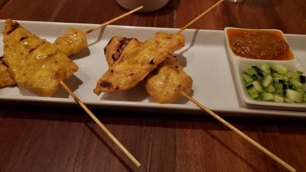 Chicken Satay · Chicken on skewer serve with cucumber salad and house peanut sauce.