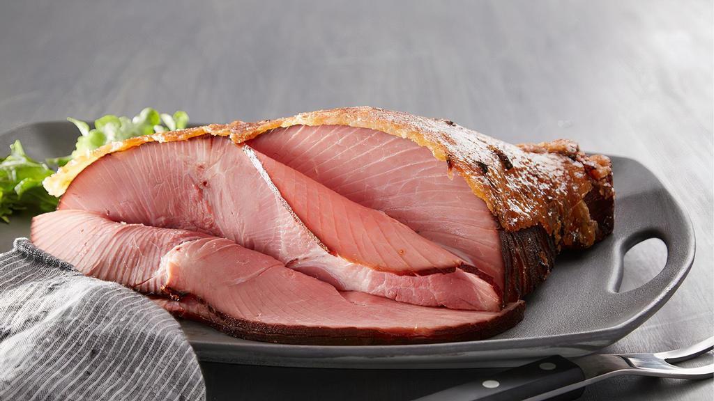 Boneless Ham, Happy Fam Dinner - 1/4 Boneless Ham · Serve the new Boneless Ham, Happy Fam Dinner any night of the week! This meal features a quarter Honey Baked Boneless Ham that is ready to serve and always moist and tender. Our Boneless Ham is smoked for up to 12 hours and is handcrafted in store with our sweet and crunchy glaze. Also included with this meal are two frozen Heat & Serve side dishes - our Cheesy Potatoes au Gratin and Green Bean Casserole (simply bake or microwave those) and a package of King's Hawaiian rolls. Serves 4-6.