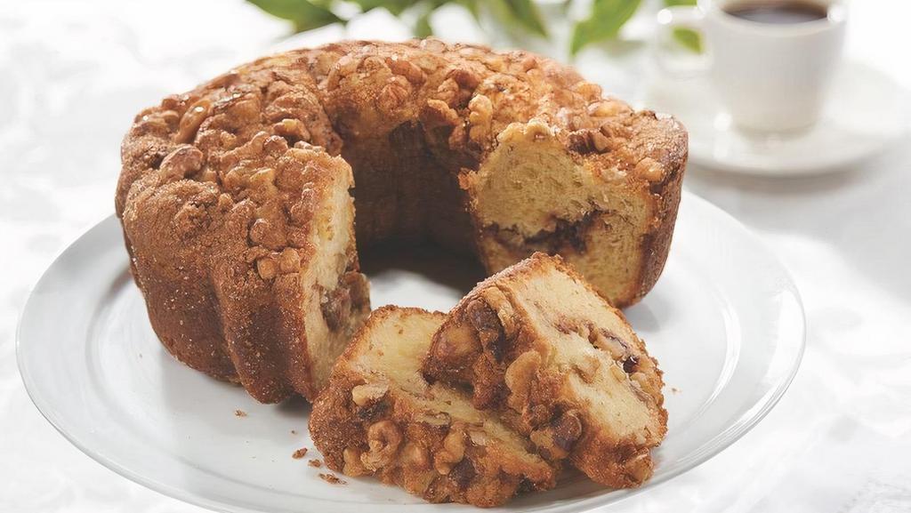 Cinnamon Walnut Coffee Cake · Our HoneyBaked Cinnamon Walnut Coffee Cake takes all the work out of dessert. Packed with mouth-watering flavor, each cake provides the perfect fuss-free solution to any event requiring a sweet finale. Whether you are planning a small tea party or a large formal gathering, our moist Coffee Cake is a perfect crowd-pleaser. Each fluffy cake layer is made with sour cream for ultimate moisture and texture. A soft layer of sweet cinnamon streusel and crunchy Mariani walnuts provides textural interest and mouth-watering flavor in each bite. Serves 10