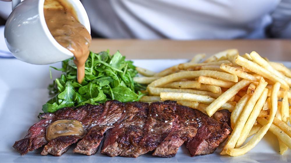 Ny Strip Steak Frites · Sliced NY strip steak, shoestring french fries, arugula, sauce au poivre