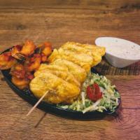 Camarones Con Tostones · Sautéed shrimp in creole sauce served with crispy golden tostones