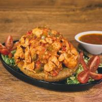 Mofongo De Pollo Guisado · Fried green plantains mashed together in a pilón with salt, our homemade broth, garlic & oli...
