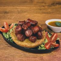 Mofongo De Longaniza · Fried green plantains mashed together in a pilón with salt, our homemade broth, garlic & oli...