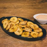 Platanitos (Fried Plantain Chips) · Thinly sliced fried plantains, seasoned with salt and served with our house dip