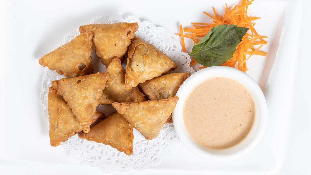 Curry Samosa · Spicy. Eight pieces. Deep-fried samosa filled with potato, onion, carrot, mushroom, and curry powder.