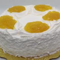 Round Pineapple Coconut Cake · Yellow Cake w/Pineapple Filling and Whipped Cream Icing Covered with Coconut.
