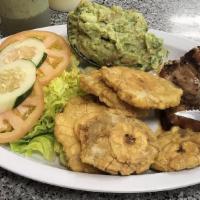 Salmon Ala Parrilla · Grilled salmon with guacamole and tostones.