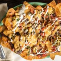 Nachos · house made chips with 3 cheeses, pico de gallo, jalapenos, sour cream & black beans topped w...