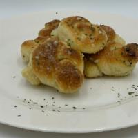 Garlic Knots · Our delicious knots prepared with our special garlic sauce. topped with grated romano & fres...