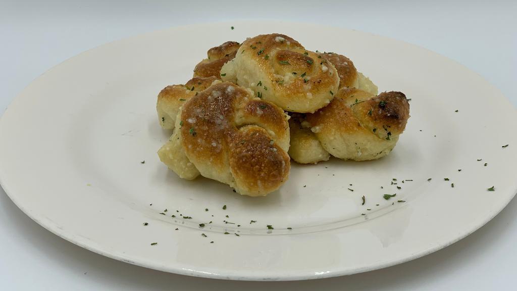 Garlic Knots · Our delicious knots prepared with our special garlic sauce. topped with grated romano & fresh parsley.