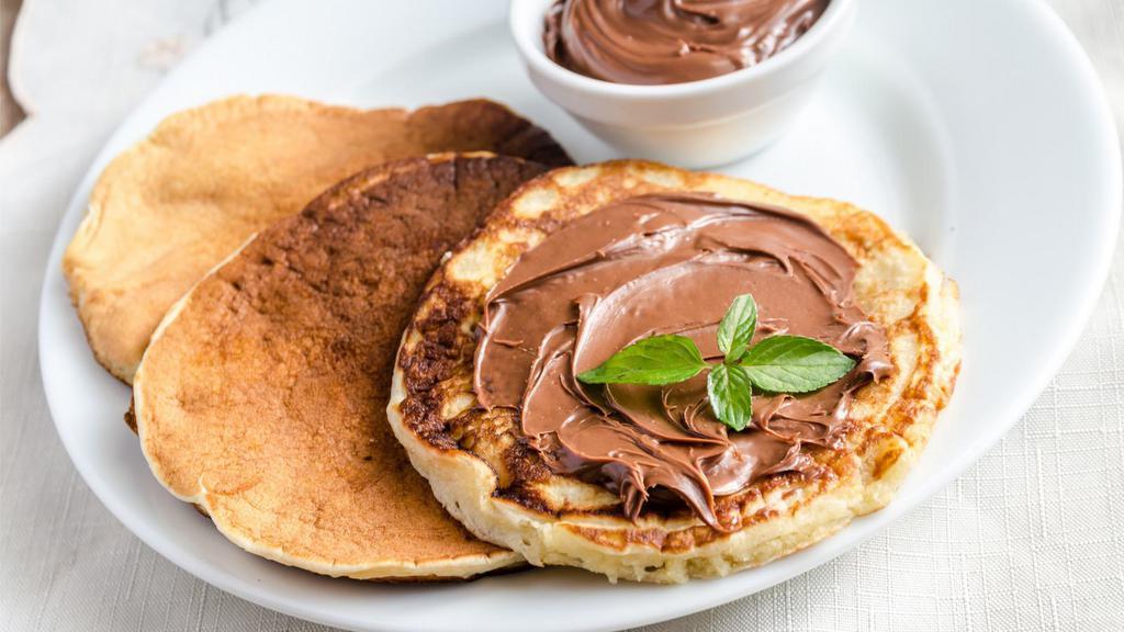 The Nutella Pancakes · Fluffy buttermilk pancakes topped nutella, syrup and butter.