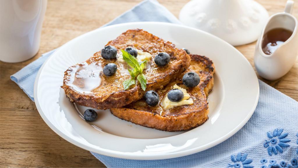 The Blueberries French Toasts · Fluffy French toasts topped blueberries, syrup and butter.