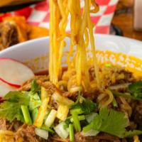Ramen Birria · Ramen Noodle Soup with Birria Consome and Birria Beef, Topped with onions an cilantro, somes...