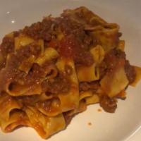 Pappardelle Beef Bolognese · Homemade fresh wide pasta in a slow cooked tomato and beef ragu sauce.