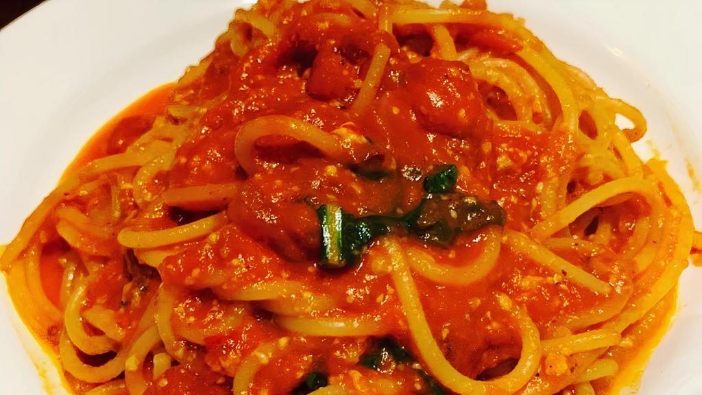 Spaghetti Al Pomodoro · Vegetarian. Spaghetti in a tomato sauce topped with Basil.