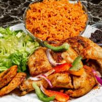 Jollof Rice · Jasmin rice cooked in spiced tomato sauce served with garden salad, sweet plantain and black...