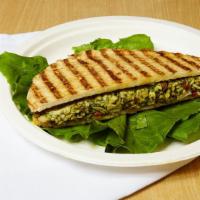 Chicken Milano Panini · Grilled chicken with pesto sauce, fresh mozzarella and sun-dried tomatoes on European flat b...