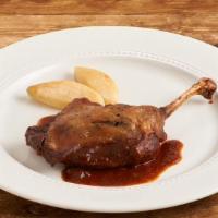 Duck Confit · Slow-cooked to perfection, cranberries, red wine reduction, wild rice.