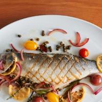 Grilled Whole Boneless Branzino · Cherry tomatoes, red onions, capers, lemon, olive oil.