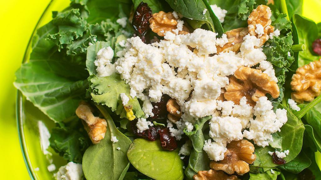 Kale Spinach Salad · Kale and spinach with walnuts, Feta, dried cranberries and our house dressing.