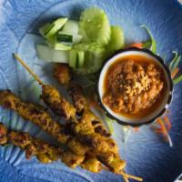 Chicken Satay (4) · Marinated chicken on a skewer with peanut turmeric sauce.
