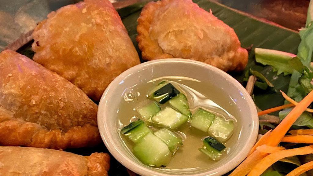 Curry Puff · Curry flavored potato, and onion in crispy puff pastry served with sweet cucumber relish.