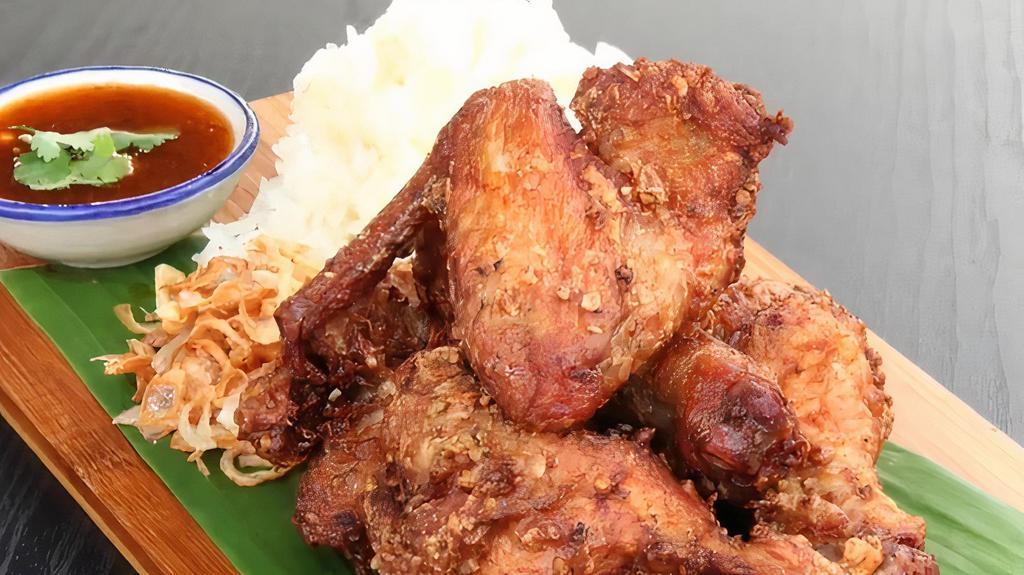 Thai Fried Chicken(Gai Tod Hat Yai) · chicken marinate ours in a rich seasoning made with lots of garlic, coriander root, peppercorns, soy sauce, sugar, and salt. Served with topped these savory little crispy fried shallots with freshly cooked sticky rice and homemade sweet chili sauce
