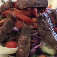 Casa Rina House Salad · Mesculine greens, red onions, cherry tomatoes, cucumbers, roasted peppers, and balsamic vina...