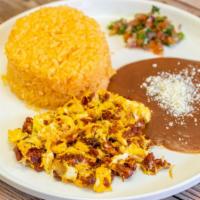 Huevos Con Chorizo / Mexican Sausage With Egg · Arroz y frijoles. / Rice and beans.